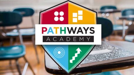 Pathways Academy Logo in front of desks